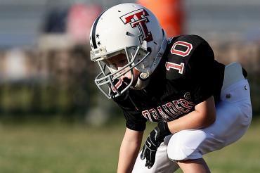 boy wearing football gear