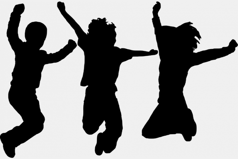 Silhouette of three kids jumping 