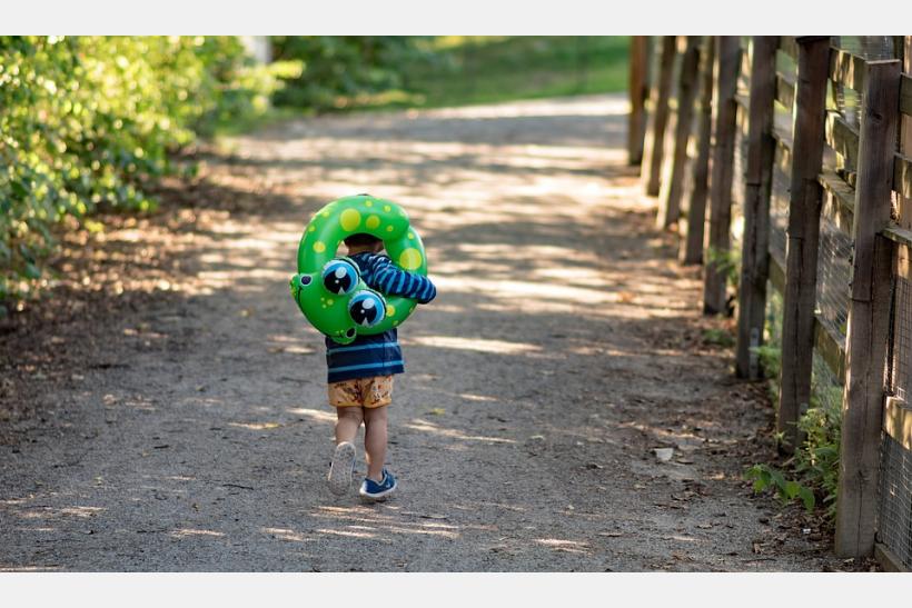 boy running with floatation device